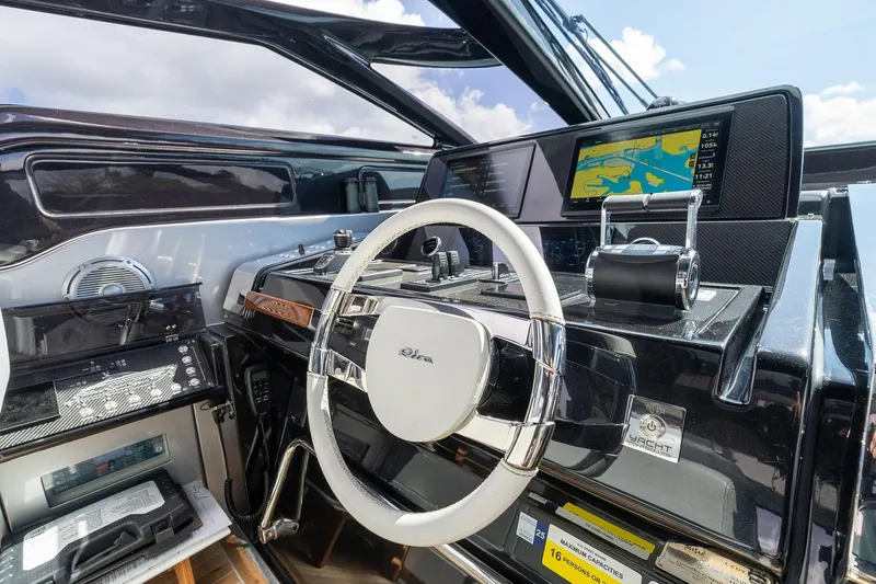 Slide: The Image of Cockpit of 2023 Riva 68 Diable yacht with modern navigation controls and steering wheel. - 19