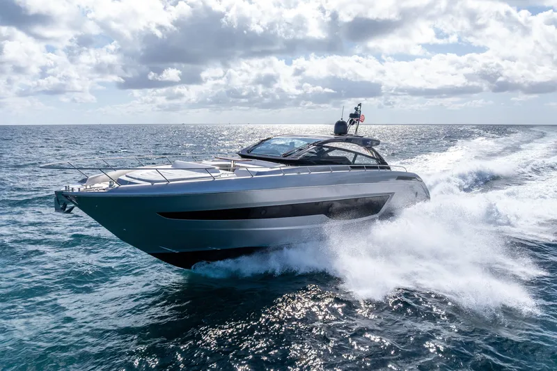 The Image of 2023 Riva 68 Diable yacht cruising on open sea under clear skies. - 2