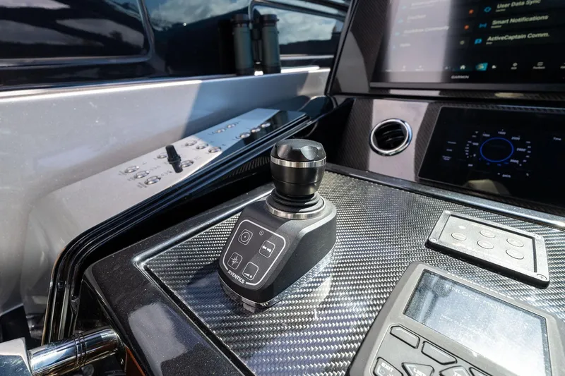 Slide: The Image of Control panel of 2023 Riva 68 Diable yacht with joystick and digital displays. - 20