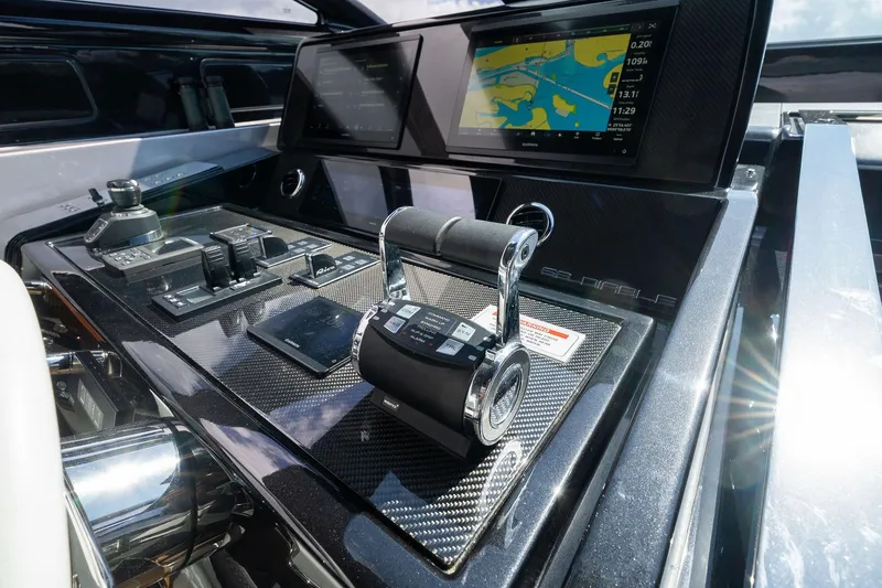 Slide: The Image of Control panel of 2023 Riva 68 Diable yacht with navigation screens and throttle levers. - 21