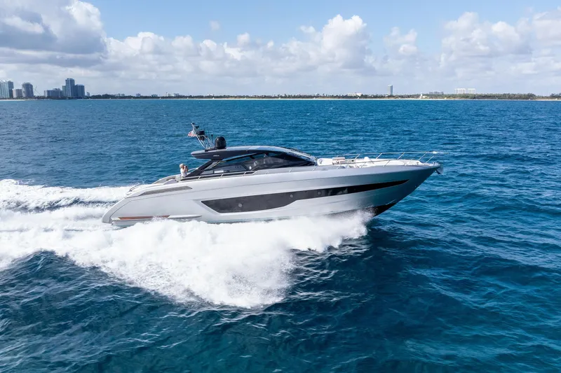 Slide: The Image of Luxury Riva 68 Diable yacht cruising near city skyline, 2023 model. - 3