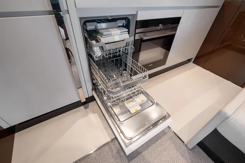 Slide: The Image of Modern kitchen with open dishwasher on Riva 68 Diable yacht, 2023 model. - 34