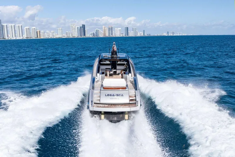 Slide: The Image of 2023 Riva 68 Diable yacht cruising near city skyline on open sea. - 6