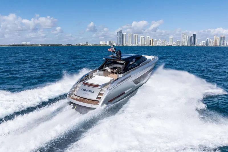 Slide: The Image of 2023 Riva 68 Diable yacht cruising near city skyline on a sunny day. - 7