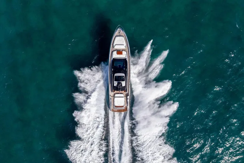 Slide: The Image of Aerial view of 2023 Riva 68 Diable yacht cruising on turquoise water. - 8