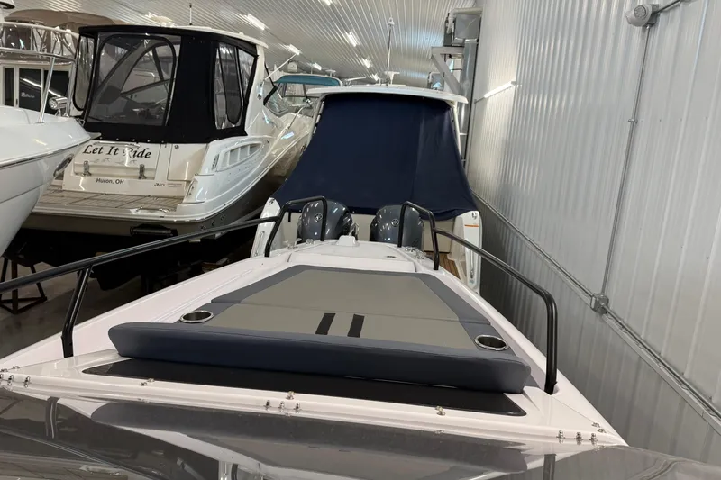 Slide: The Image of 2023 Axopar 25 Cross Bow boat in showroom, sleek design, modern features. - 10