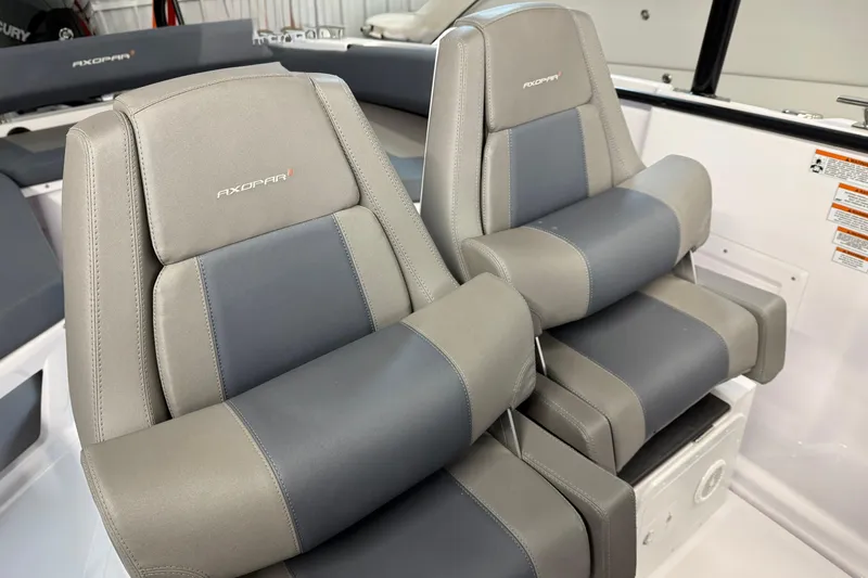 Slide: The Image of 2023 Axopar 25 Cross Bow seats, featuring gray and blue upholstery in a modern design. - 12