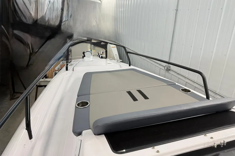 Slide: The Image of 2023 Axopar 25 Cross Bow boat interior with cushioned seating and cup holders. - 15