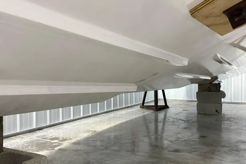 Slide: The Image of 2023 Axopar 25 Cross Bow hull in storage, showcasing sleek design and structure. - 25