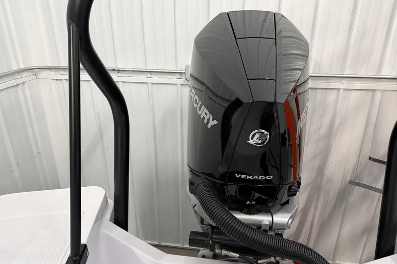 Slide: The Image of 2023 Axopar 25 Cross Bow with Mercury Verado engine in a storage facility. - 4