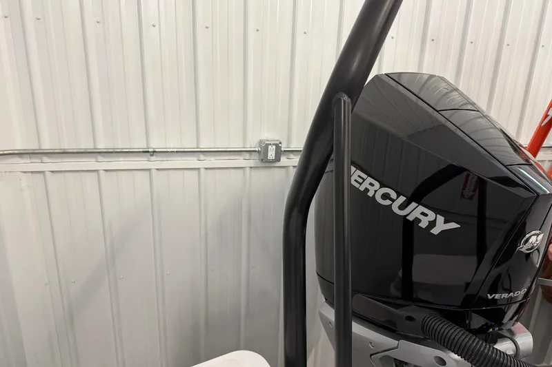 Slide: The Image of 2023 Axopar 25 Cross Bow with Mercury Verado engine in a garage setting. - 5