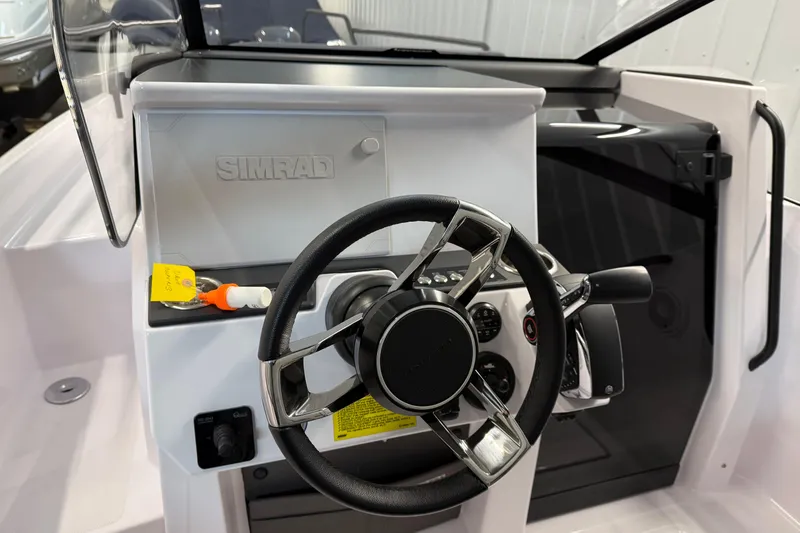 Slide: The Image of 2023 Axopar 25 Cross Bow steering console with Simrad display and modern controls. - 7
