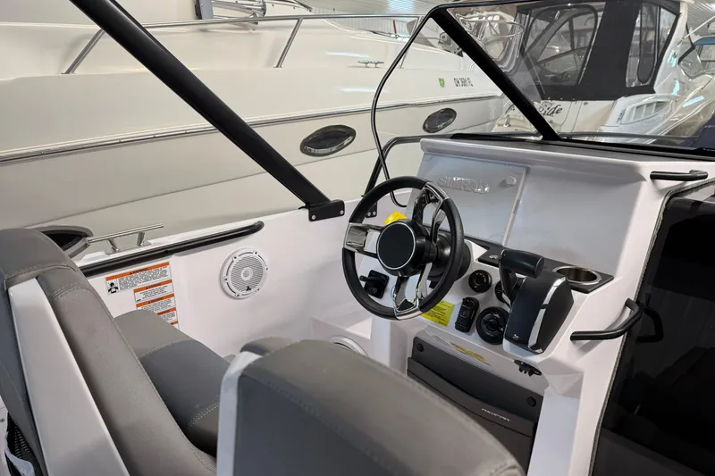 Slide: The Image of 2023 Axopar 25 Cross Bow cockpit with steering wheel and controls, showcasing modern design. - 8