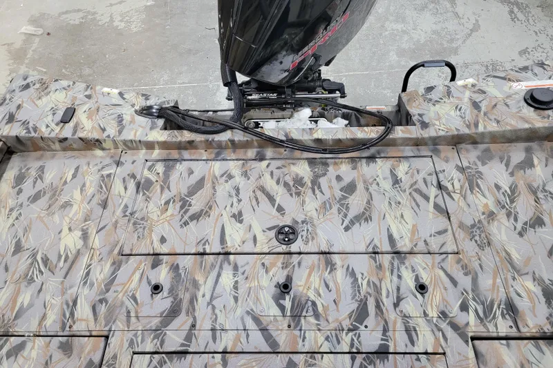 Slide: The Image of 2025 Ranger RB210 boat deck with camo pattern and motor. - 12