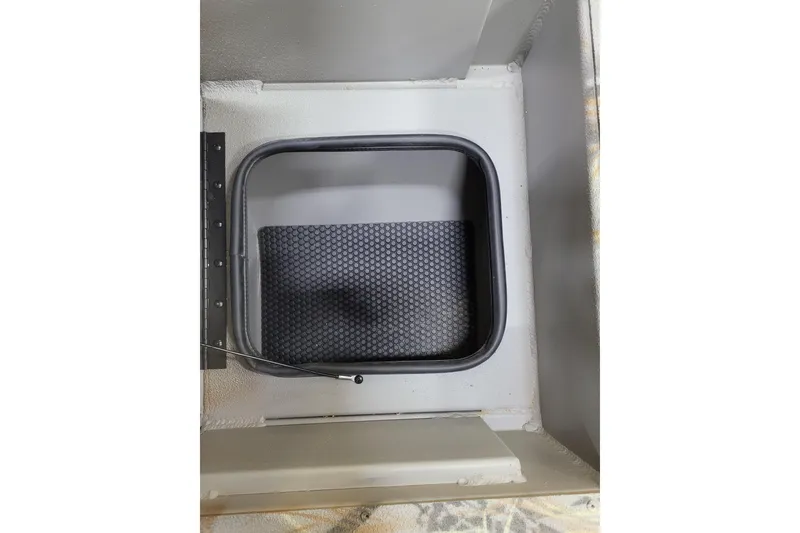 Slide: The Image of Ranger RB210 2025 model interior compartment with textured mat and secure latch. - 16