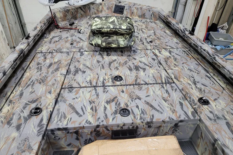 Slide: The Image of 2025 Ranger RB210 boat interior with camouflage pattern and storage compartments. - 19