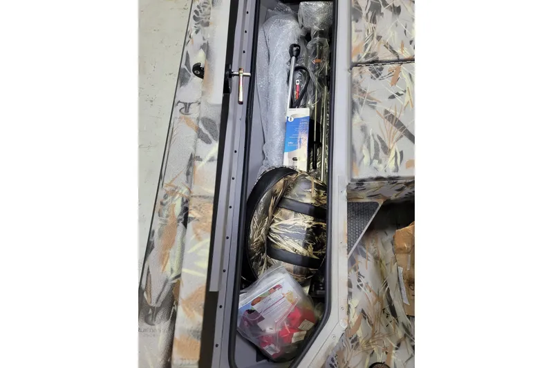 Slide: The Image of Storage compartment of 2025 Ranger RB210 boat with fishing gear and accessories. - 21