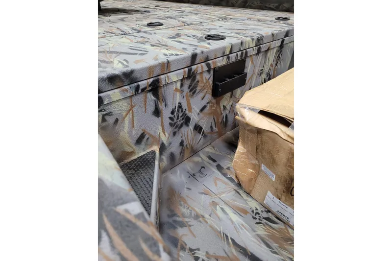 Slide: The Image of 2025 Ranger RB210 interior with camouflage design and storage compartments. - 28