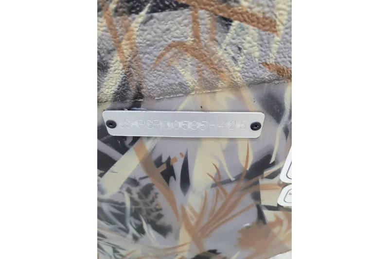Slide: The Image of Ranger RB210 2025 model with camouflage pattern and serial number plate. - 29