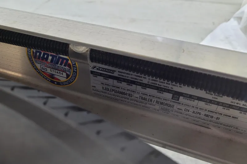 Slide: The Image of Close-up of a 2025 Ranger RB210 trailer label with safety and manufacturing details. - 31