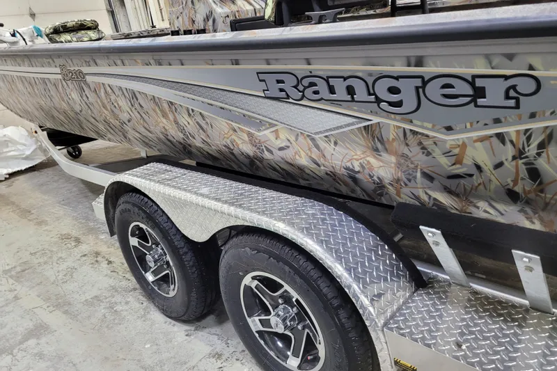 Slide: The Image of 2025 Ranger RB210 boat with camouflage design on a dual-axle trailer. - 5