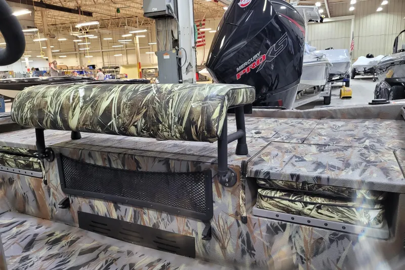 Slide: The Image of 2025 Ranger RB210 boat interior with camouflage seating and Mercury Pro XS engine in a showroom. - 8