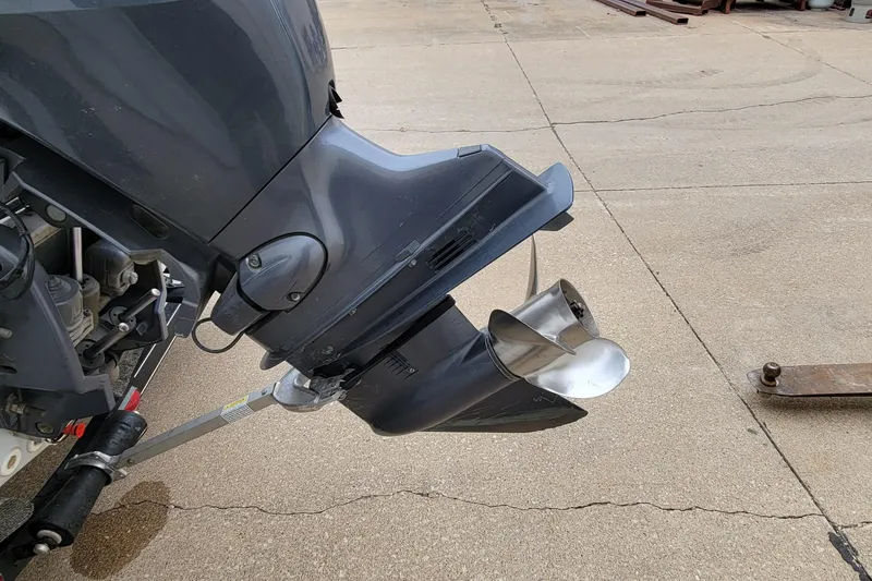 Slide: The Image of Outboard motor of a 1999 Ranger 107 Cherokee boat on concrete surface. - 12