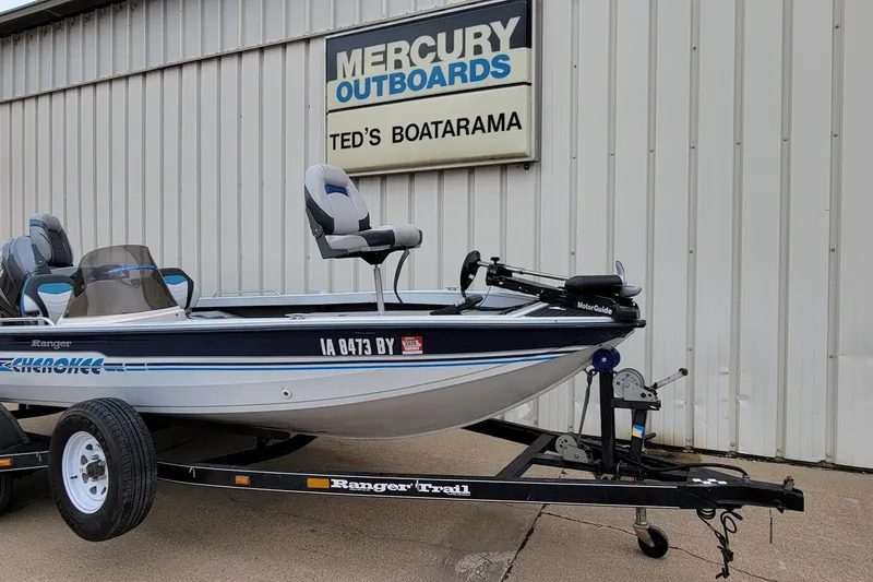 Slide: The Image of 1999 Ranger 107 Cherokee boat on trailer at Ted's Boatarama, Mercury Outboards sign visible. - 17