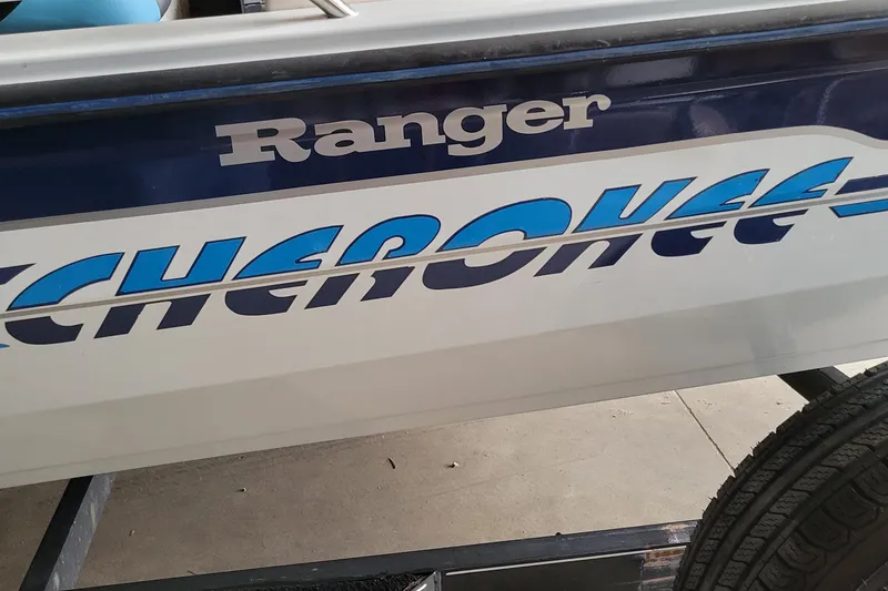 Slide: The Image of 1999 Ranger 107 Cherokee boat with bold blue lettering on the side. - 3