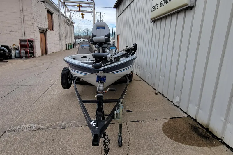 Slide: The Image of 1999 Ranger 107 Cherokee boat on trailer outside Ted's Boating shop. - 4