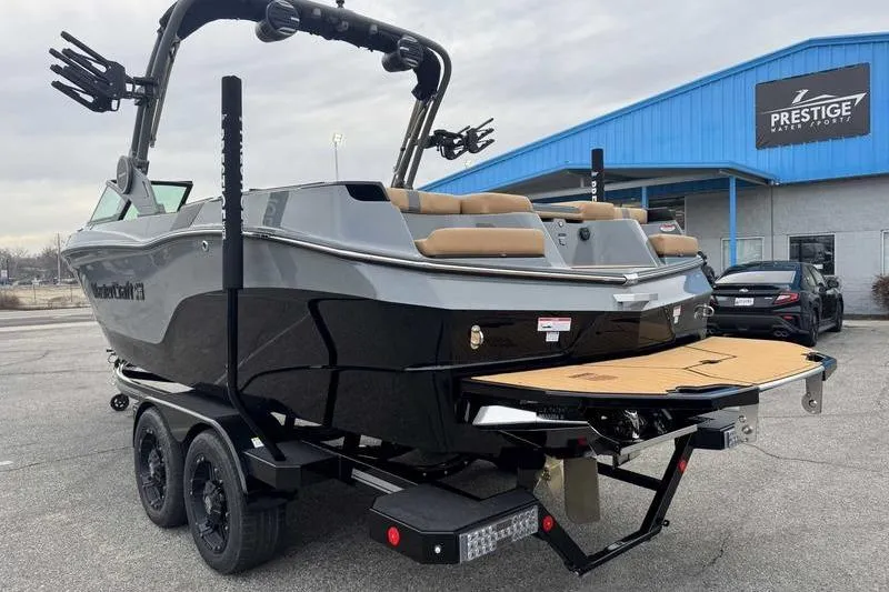 Slide: The Image of 2026 MasterCraft XT23 boat on trailer at dealership, showcasing sleek design and modern features. - 10