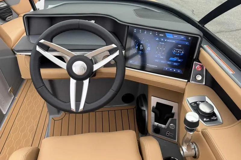 Slide: The Image of 2026 MasterCraft XT23 boat dashboard with modern steering wheel and touchscreen controls. - 14