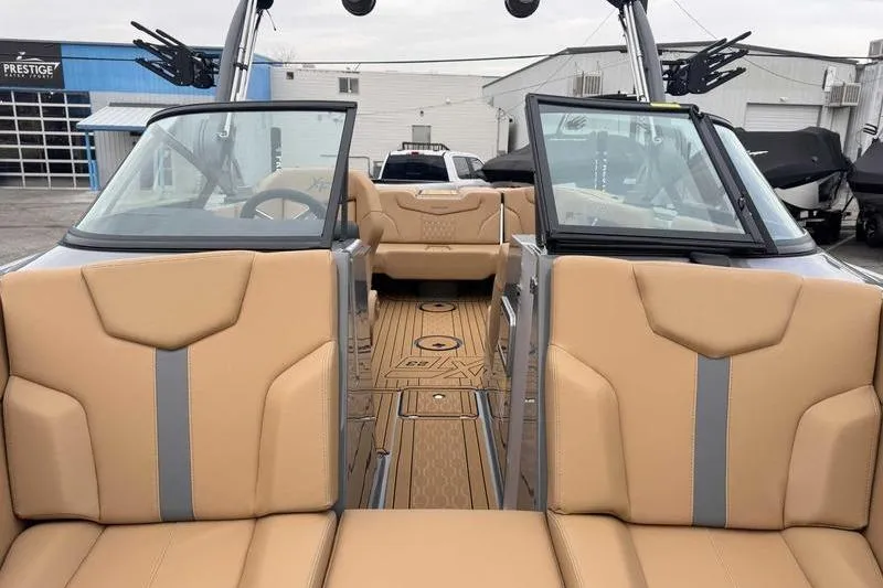Slide: The Image of 2026 MasterCraft XT23 boat interior with tan seats and modern design. - 15