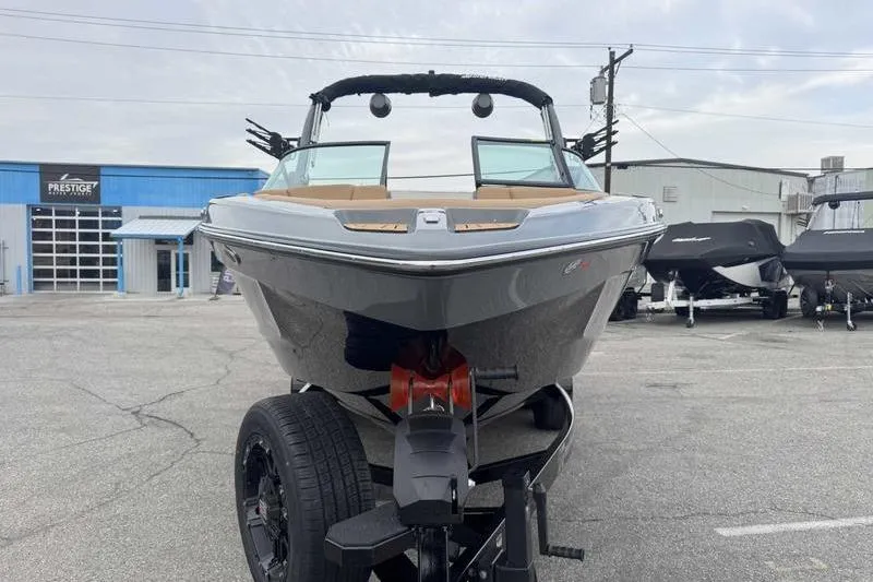 Slide: The Image of 2026 MasterCraft XT23 boat on trailer in parking lot, front view. - 3