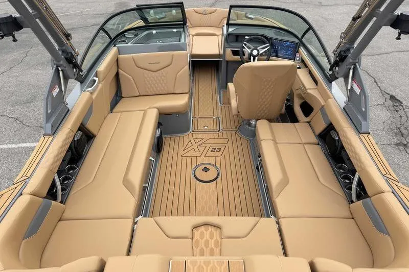 Slide: The Image of 2026 MasterCraft XT23 boat interior with tan seating and modern dashboard. - 7
