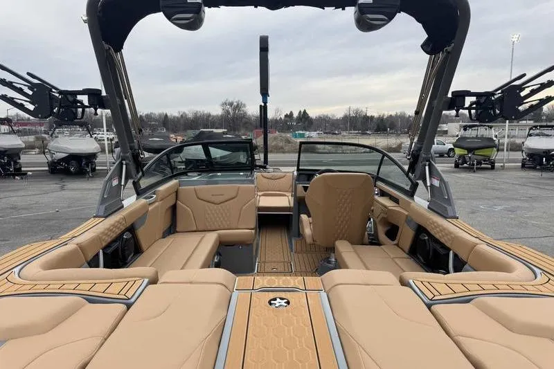 Slide: The Image of 2026 MasterCraft XT23 boat interior with tan seating and sleek design. - 8