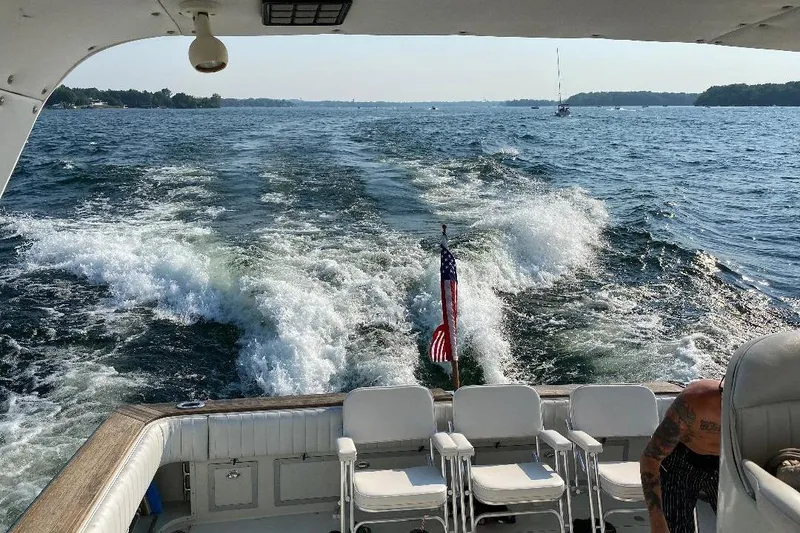 Slide: The Image of 1984 Trojan 11 Meter Express cruising on a lake, leaving a wake behind. - 5