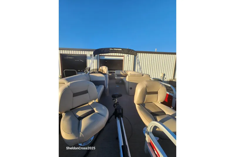 Slide: The Image of 2022 Sun Tracker Fishin' Barge 20 DLX pontoon boat with beige seating and canopy. - 3