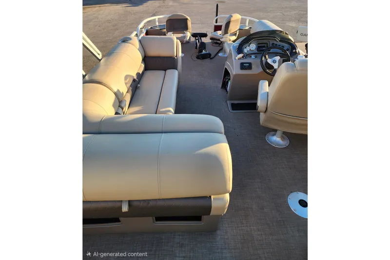 Slide: The Image of 2022 Sun Tracker Fishin' Barge 20 DLX interior with beige seating and steering console. - 7