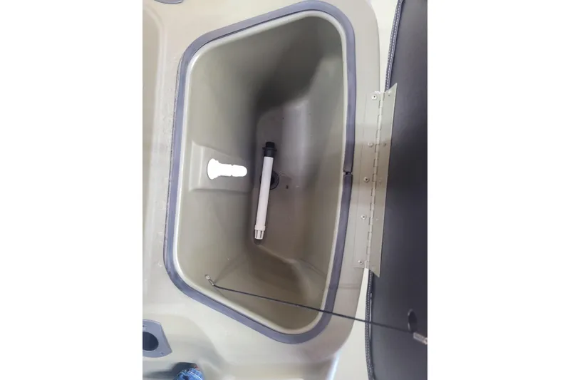 Slide: The Image of Livewell compartment in 2026 Tracker Grizzly 1860 CC boat, featuring a drain and aerator. - 11