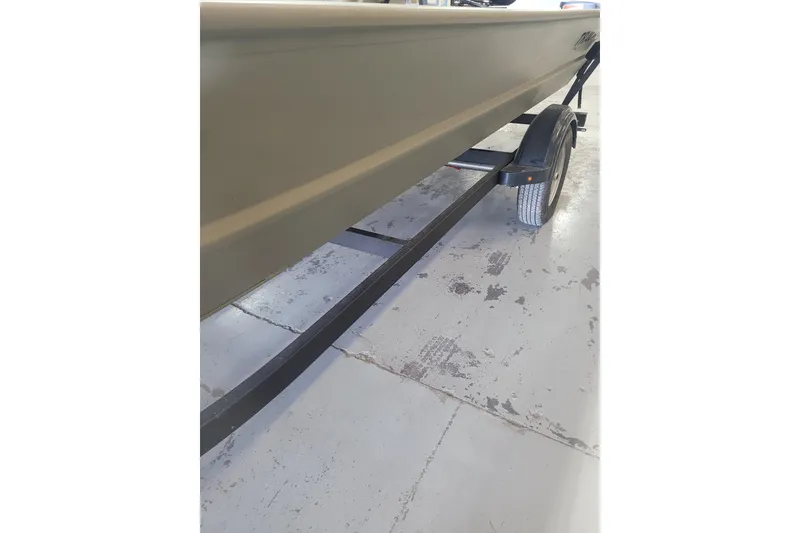 Slide: The Image of 2026 Tracker Grizzly 1860 CC boat on trailer, side view in garage. - 12