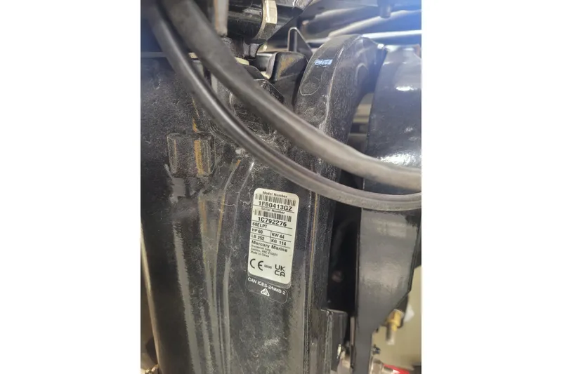 Slide: The Image of Close-up of a 2026 Tracker Grizzly 1860 CC engine label with specifications. - 16