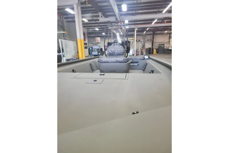 Slide: The Image of 2026 Tracker Grizzly 1860 CC boat interior in a factory setting. - 17