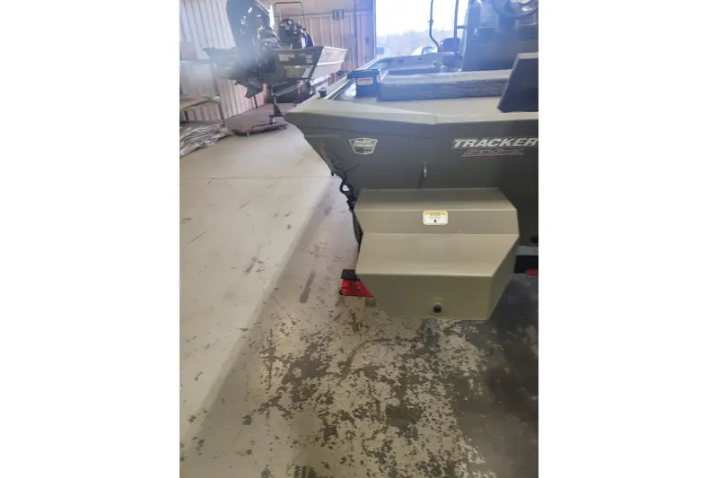 Slide: The Image of 2026 Tracker Grizzly 1860 CC boat in a garage, rear view. - 19