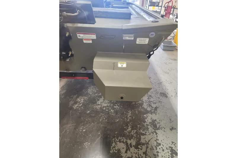 Slide: The Image of 2026 Tracker Grizzly 1860 CC boat stern view in a workshop setting. - 20