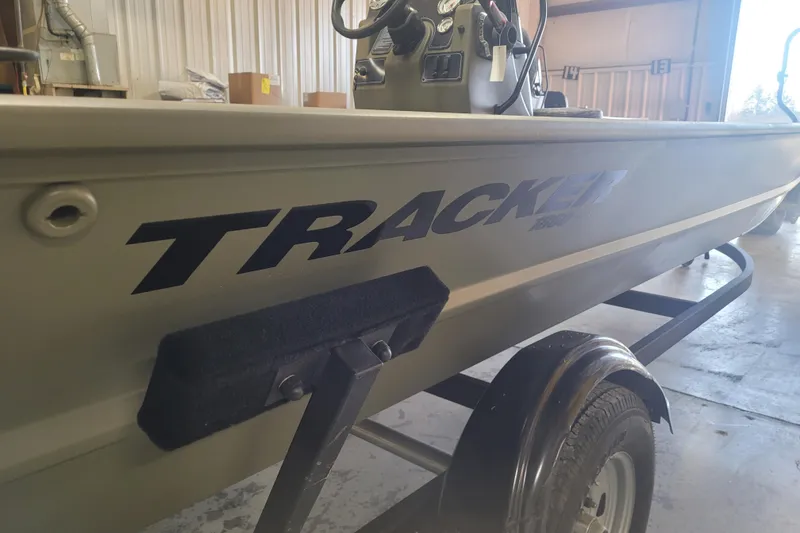 Slide: The Image of 2026 Tracker Grizzly 1860 CC boat on trailer in a garage setting. - 22