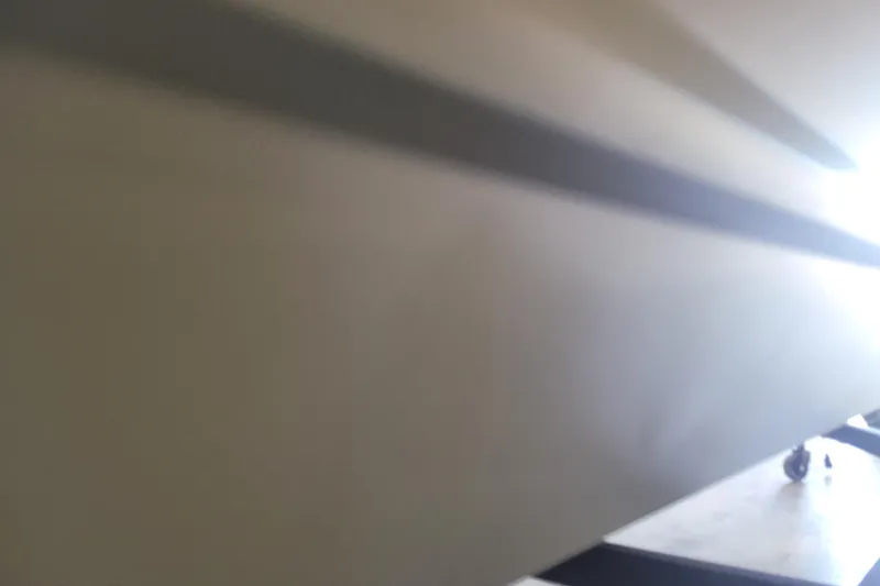 Slide: The Image of 2026 Tracker Grizzly 1860 CC boat hull, close-up view with shadow detail. - 23