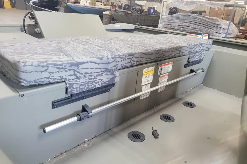 Slide: The Image of 2026 Tracker Grizzly 1860 CC boat interior with camo seating and storage compartments. - 24