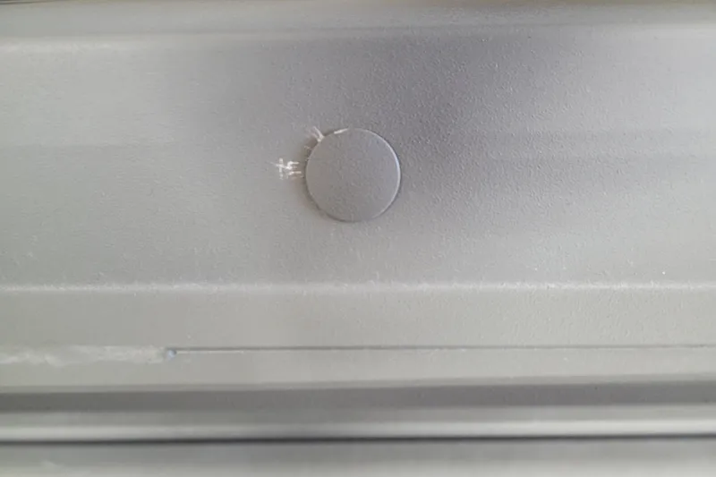 Slide: The Image of Close-up of a 2026 Tracker Grizzly 1860 CC boat's metallic surface detail. - 3