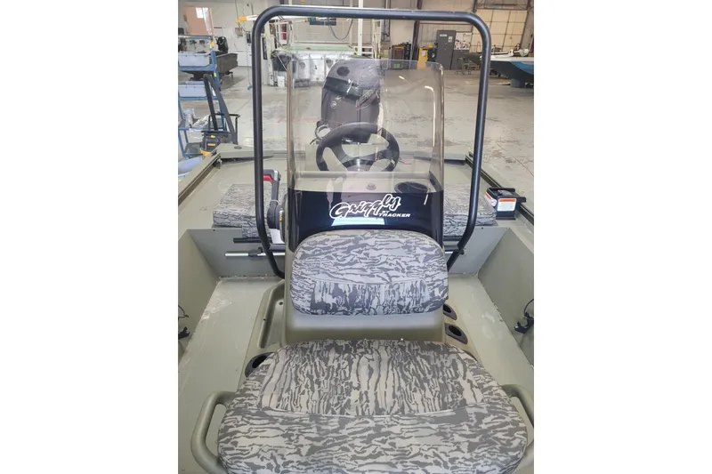 Slide: The Image of 2026 Tracker Grizzly 1860 CC boat interior with camouflage seats and steering console. - 4
